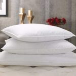 a stack of pillows on a bed